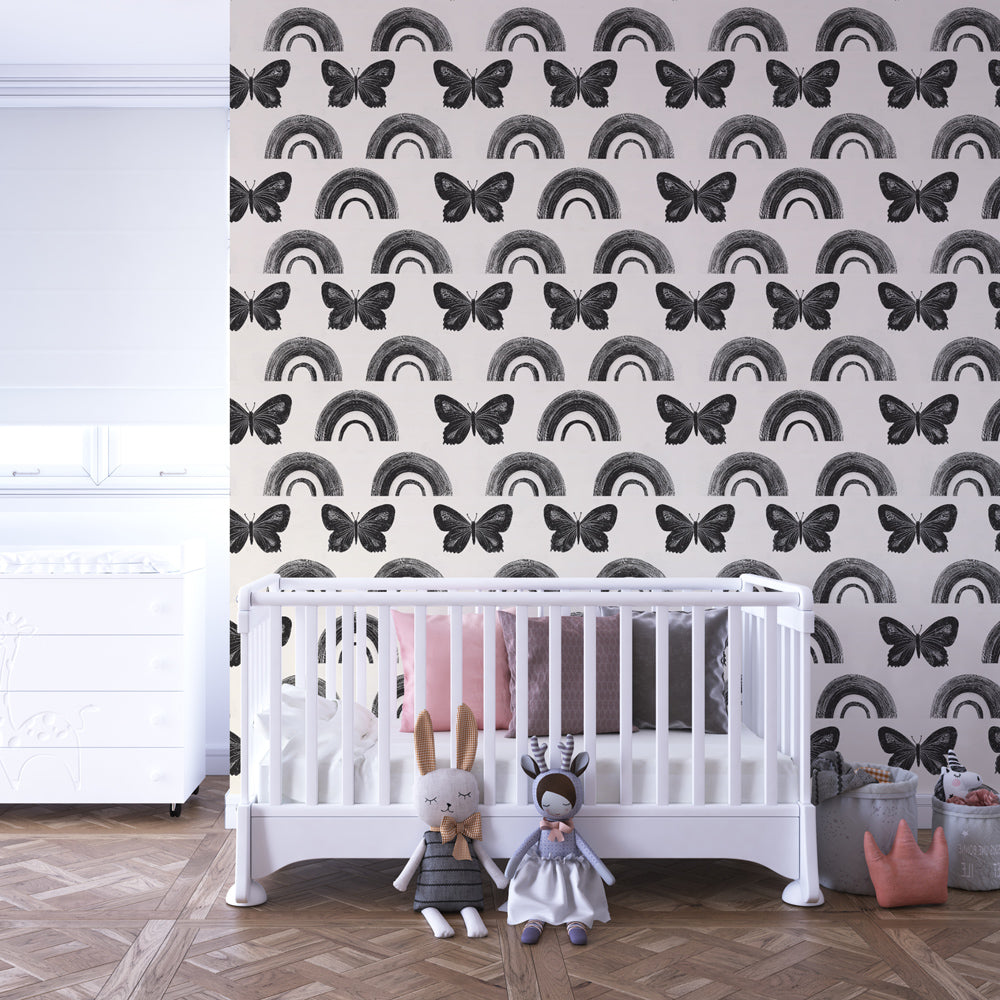 Black butterfly and rainbow wallpaper creating magical atmosphere in children's bedroom interior