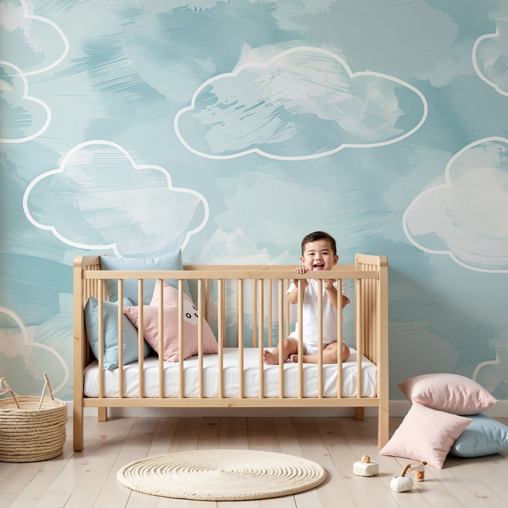 Soft blue watercolor cloud mural wallpaper in peaceful baby nursery setting by Kids-Mundo