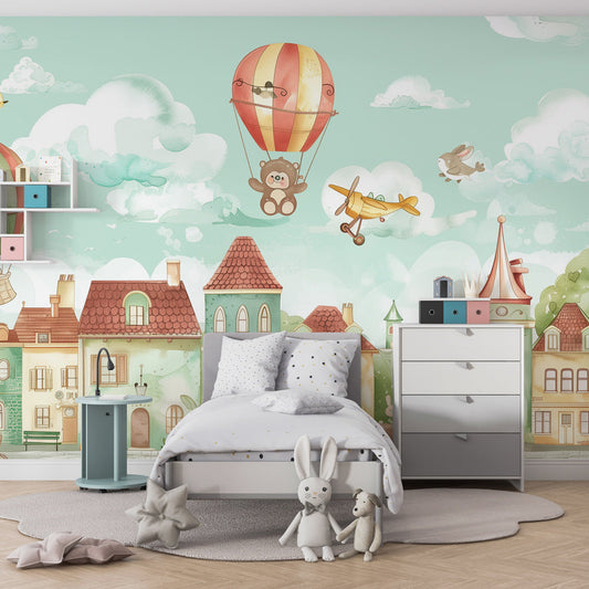 Kids-Mundo hot air balloon village wall mural behind a bed in a cheerful kids bedroom
