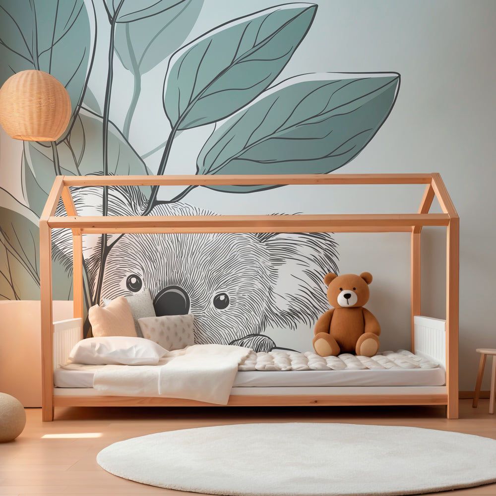 Forest themed koala wallpaper creating peaceful children's bedroom atmosphere with green foliage