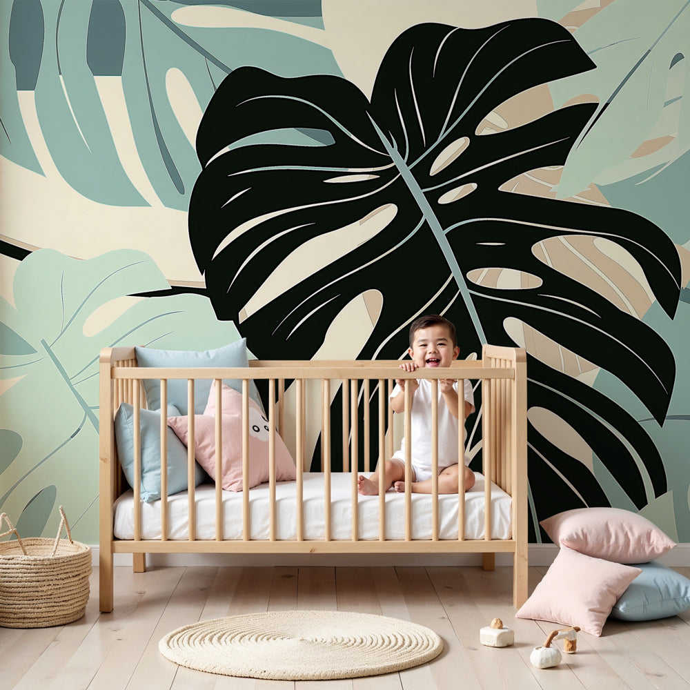 Monstera leaves mural wallpaper in modern nursery with natural wood crib by Kids-Mundo