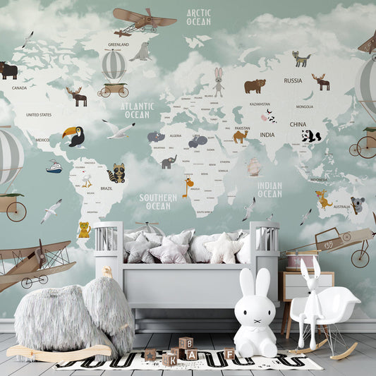 Kids-Mundo animal world map mural on a kids' bedroom wall, orcas and dolphins swimming beneath snowy mountains.