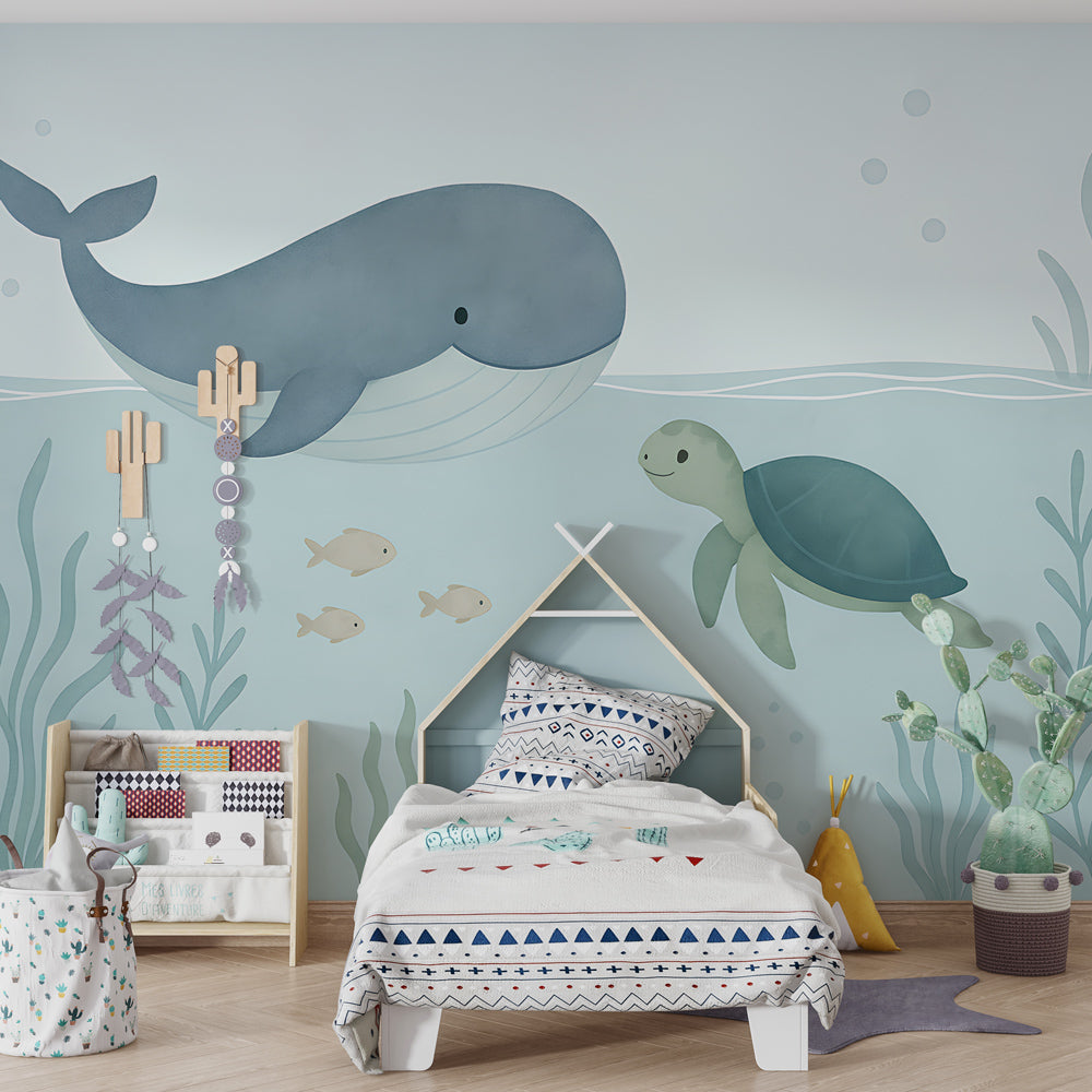 Whale and turtle wallpaper creating calming underwater theme in children's bedroom
