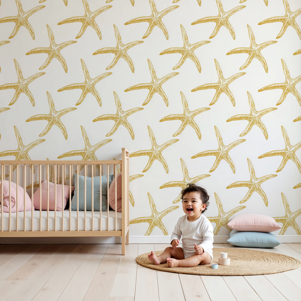 Golden starfish mural wallpaper in bright nursery with coastal decor by Kids-Mundo
