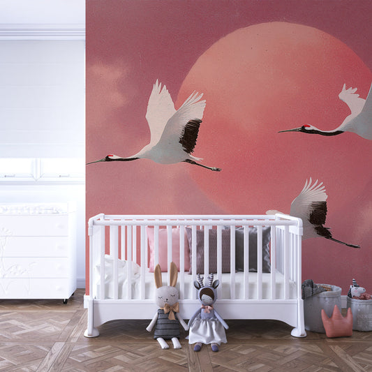Kids-Mundo pink sky cranes wall mural styled in a bright kids' bedroom with soft furnishings.