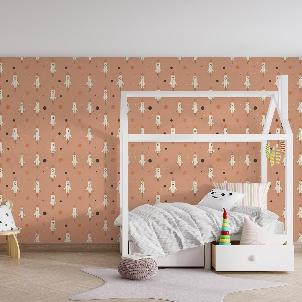 Space rocket wallpaper creating magical kids bedroom with pink planets and stars decor