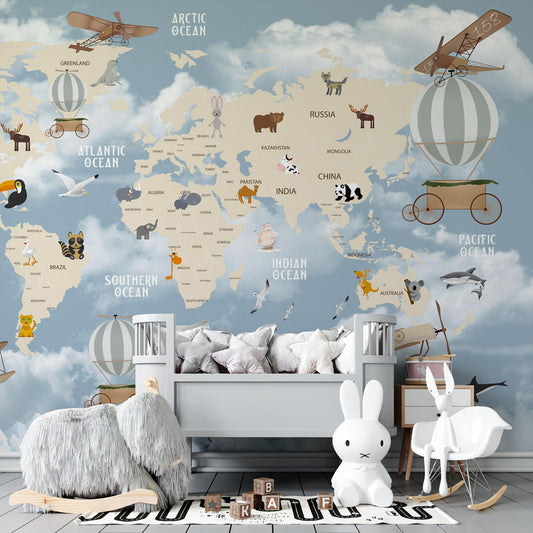 Kids-Mundo adventure world map wall mural behind a bed in a bright kids bedroom