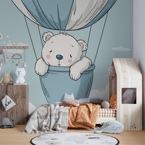 Hot air balloon bear wallpaper in cozy toddler bedroom with natural wood furniture