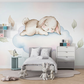 Sleeping bunny on cloud mural wallpaper behind white crib in modern baby nursery by Kids-Mundo