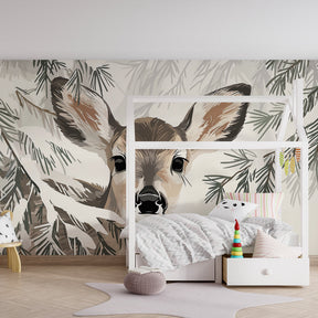 Serene baby room with deer mural wallpaper creating calming forest atmosphere for children
