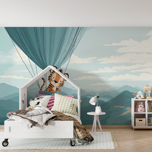 Kids-Mundo tiger balloon wall mural covering a nursery feature wall with misty blue mountains