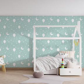 Dreamy balloon wallpaper creating peaceful children's bedroom with mint green backdrop