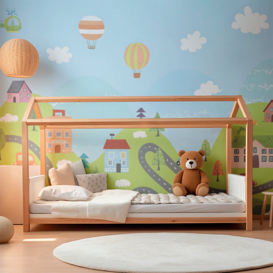 Kids-Mundo balloon town wall mural behind a bed in a cheerful kids bedroom