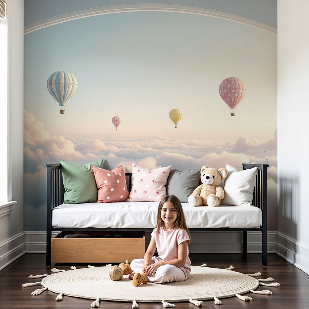 Kids-Mundo hot air balloon sunset archway wall mural styled above a cot in a soft dreamy nursery