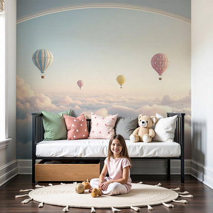 Kids-Mundo hot air balloon sunset archway wall mural styled above a cot in a soft dreamy nursery