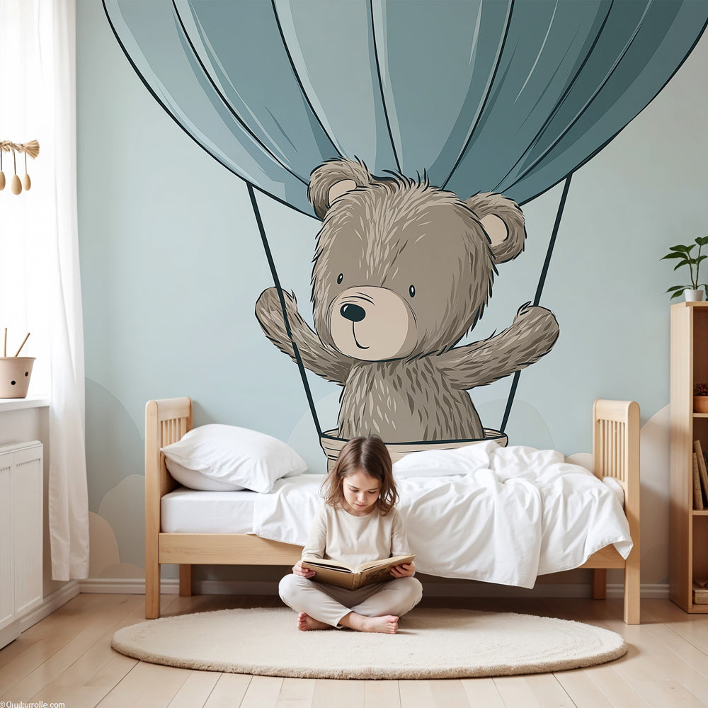 Bear hot air balloon mural wallpaper in soft blue nursery with white crib by Kids-Mundo
