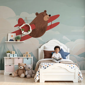 Bear pilot mural wallpaper creating aviation-themed nursery decor with mountain landscape by Kids-Mundo