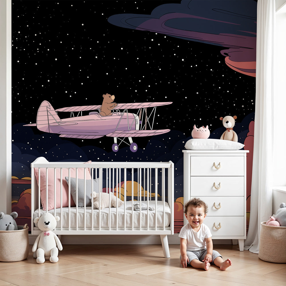 Bear pilot mural wallpaper in cozy nursery with pink airplane and starlit sky by Kids-Mundo