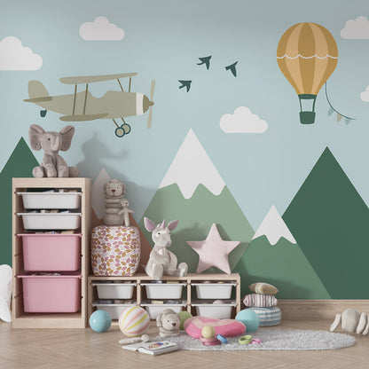 Kids-Mundo biplane and balloon mountain wall mural behind a bed in a kids bedroom.