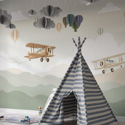 Kids-Mundo biplane and balloon mural styled in a nursery with a cot and rug