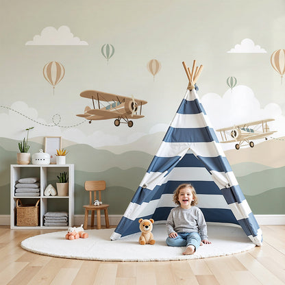 Kids-Mundo biplane flight trail wall mural in a warm-toned kids bedroom with a bed