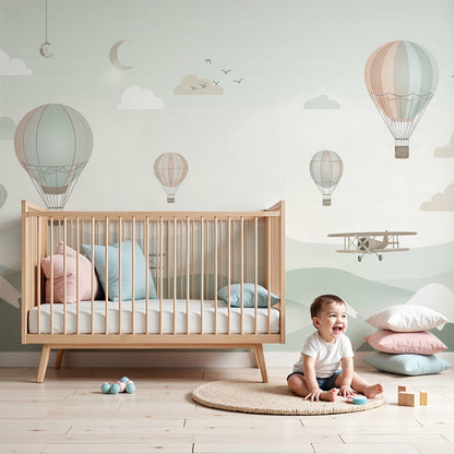 Kids-Mundo hot air balloon wall mural with biplanes and snowy mountains in a baby nursery