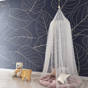 Navy blue botanical wallpaper creating serene nursery atmosphere with golden leaf motifs