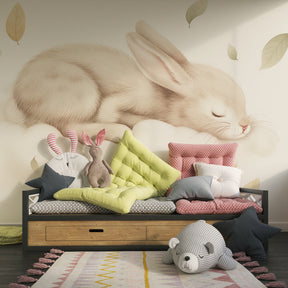 Soft neutral bunny cloud mural wallpaper complementing minimalist nursery furniture