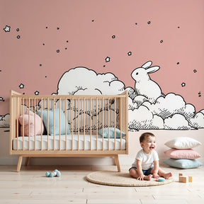 Bunny cloud mural wallpaper creating dreamy pink nursery atmosphere by Kids-Mundo