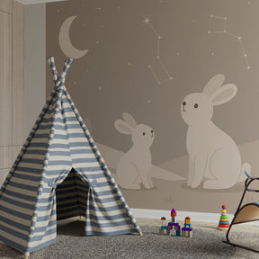 Star-themed bunny mural wallpaper for kids room with natural wood accents and cozy textiles