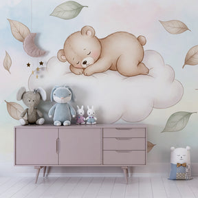 Dreamy bear on cloud mural wallpaper complementing white nursery furniture by Kids-Mundo