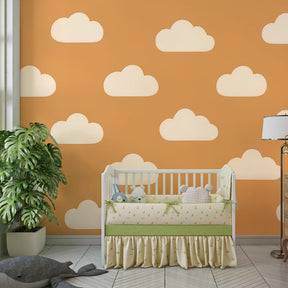 Dreamy cloud wallpaper in children's bedroom with warm beige and orange background tones