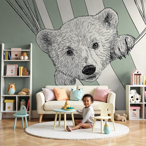 Curious bear mural wallpaper in cozy nursery setting with natural wood furniture by Kids-Mundo