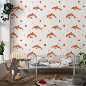 Playful dolphins wallpaper with soft pink tones decorating children's bedroom interior