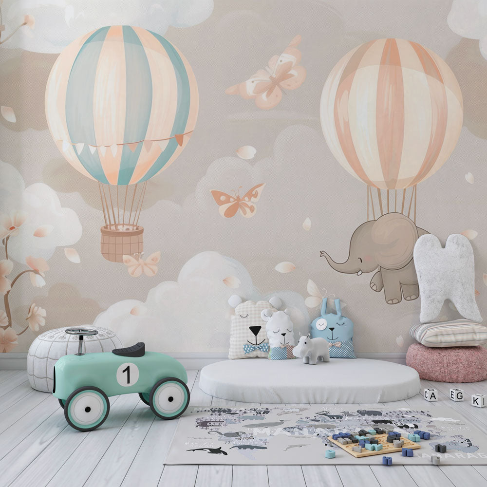 Kids-Mundo hot air balloon and elephant wall mural in a pastel pink and blue kids' bedroom setting.