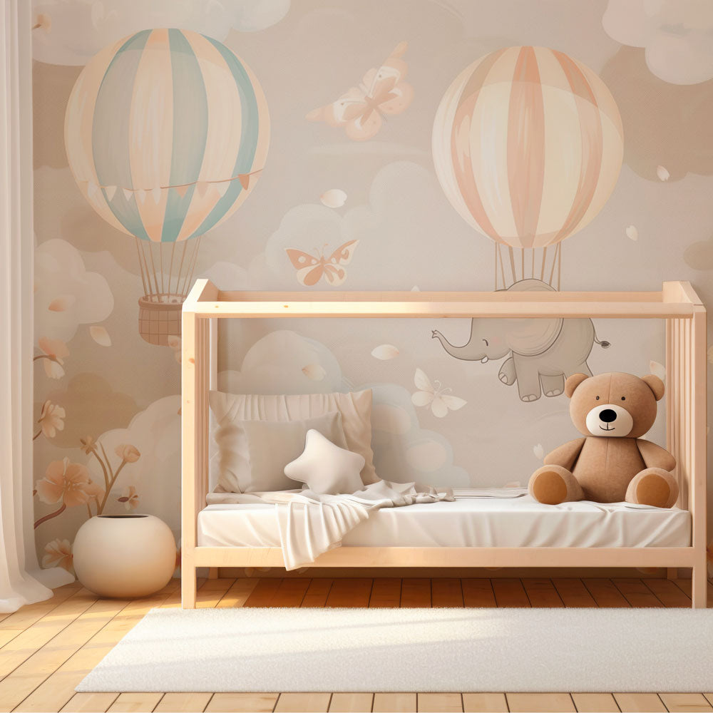 Kids-Mundo dreamy elephant balloon mural brightening a playroom wall with soft clouds and butterflies.