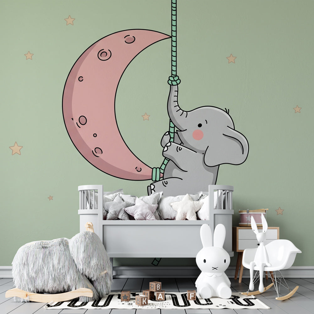 Whimsical elephant climbing pink moon wallpaper in cozy children's bedroom setting