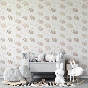 Gentle elephant mural wallpaper creating cozy reading corner in baby nursery
