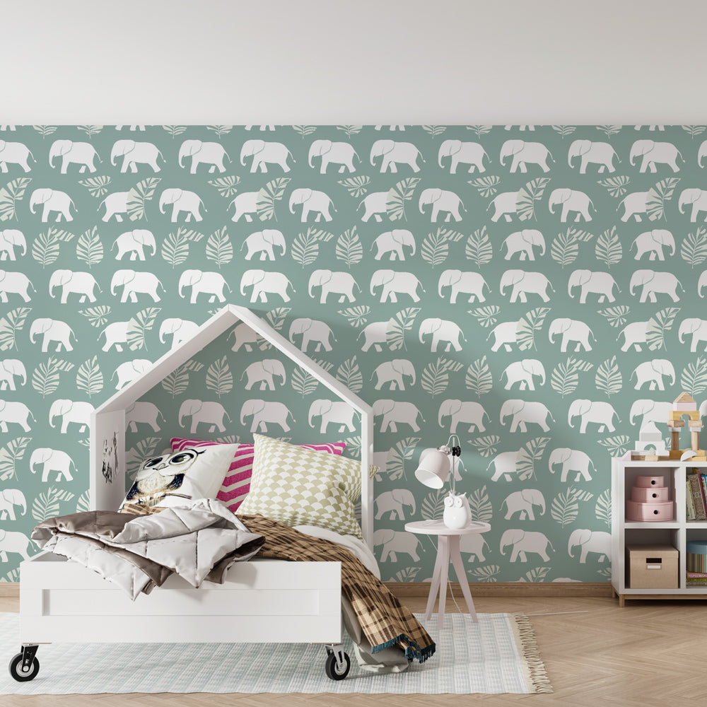 Tropical elephant mural wallpaper in children's playroom with wooden furniture and soft textiles