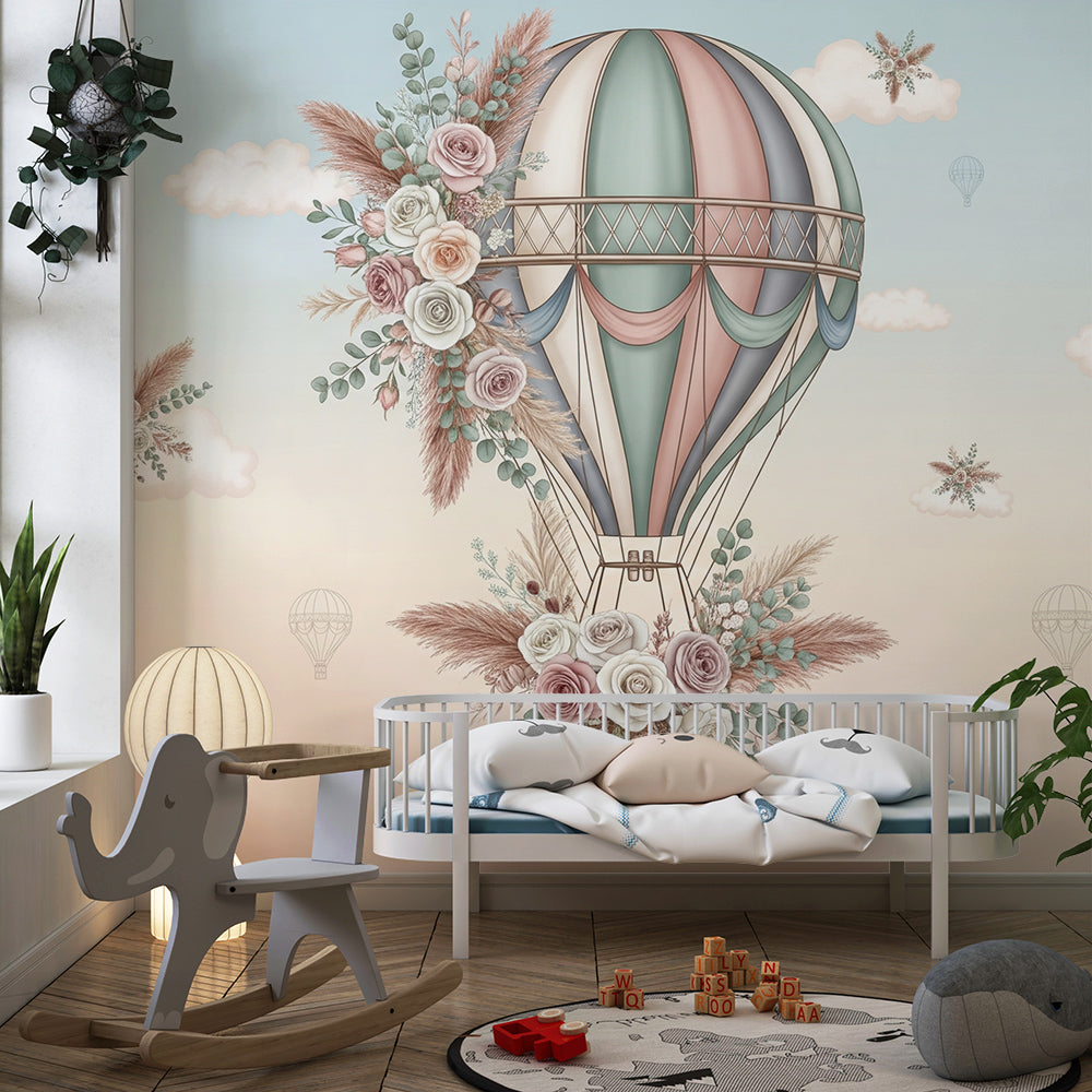 Kids-Mundo hot air balloon wall mural on a child's bedroom wall, decorated with delicate roses and pastel clouds.