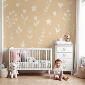 Delicate floral mural wallpaper in beige nursery room with white botanical motifs by Kids-Mundo