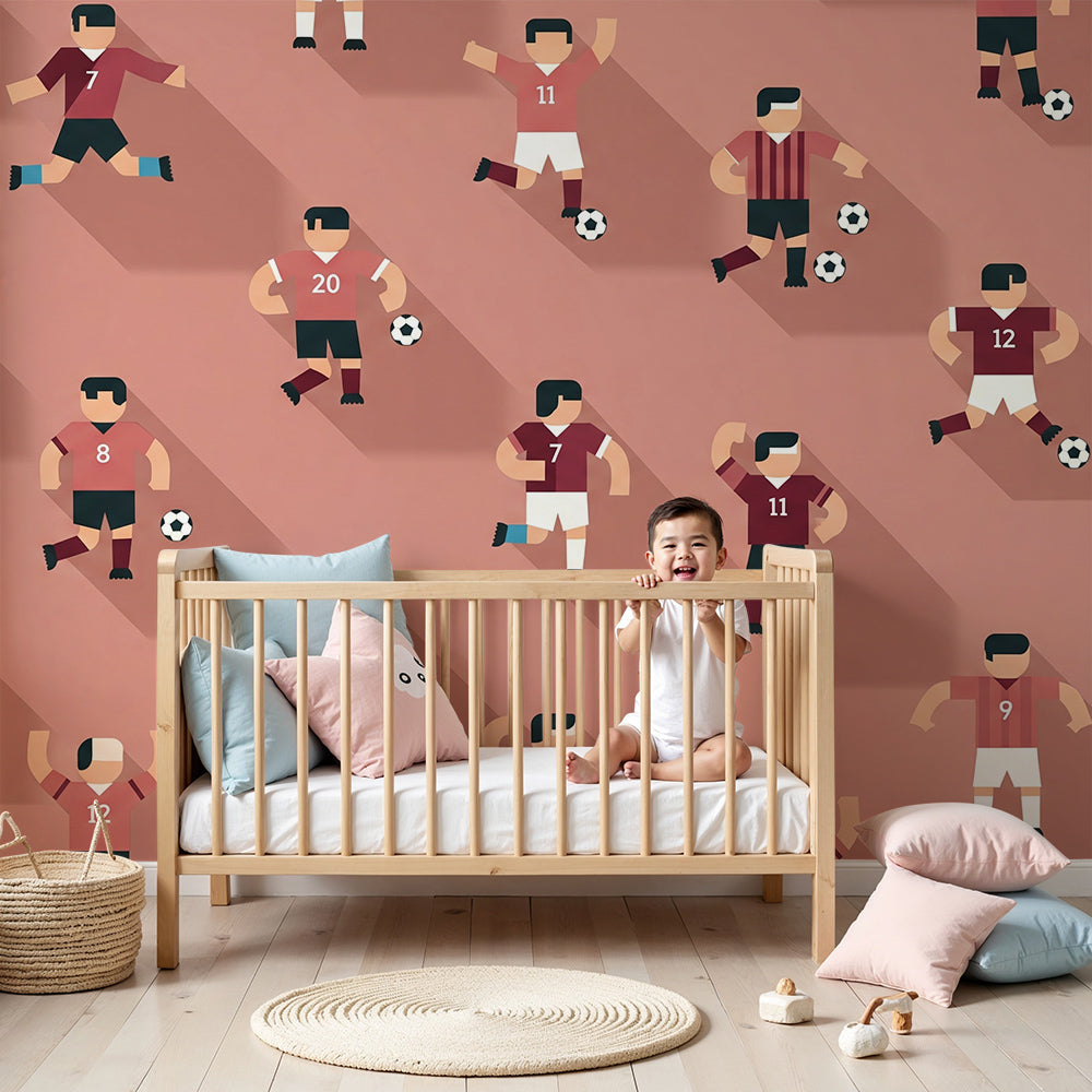 Kids-Mundo football players wall mural styled in a warm terracotta pink nursery for a baby boy.