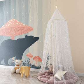 Woodland bear and mushroom wallpaper in cozy children's bedroom setting