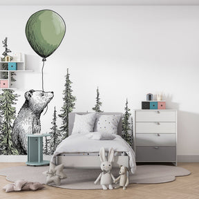 Woodland bear mural wallpaper with natural wood furniture in children's room setting