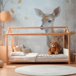 Serene forest deer wallpaper creating cozy reading nook for kids with nature-inspired decor