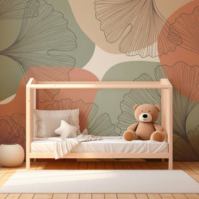 Modern ginkgo botanical mural wallpaper in children's bedroom with soft green and orange tones by Kids-Mundo