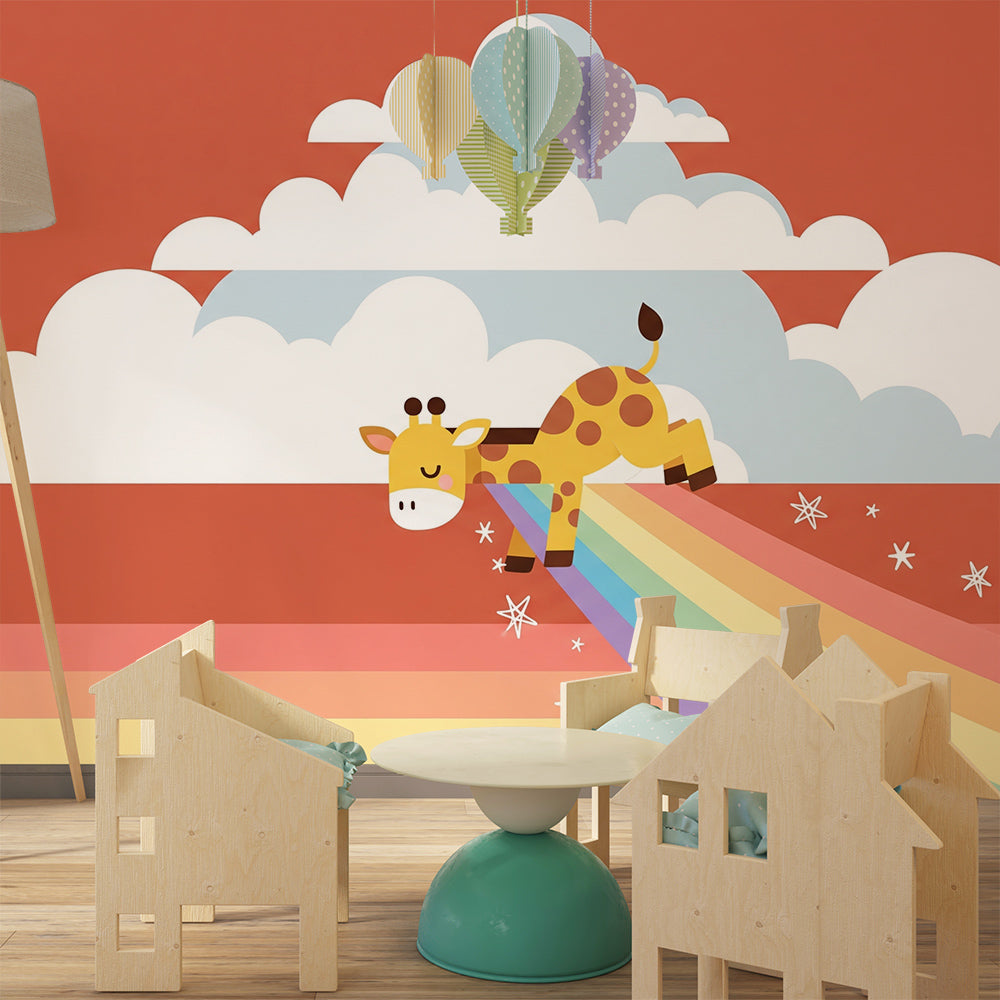 Kids-Mundo rainbow wall mural featuring a giraffe sliding on clouds in a kids bedroom wall