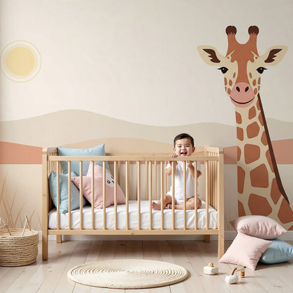 Kids-Mundo giraffe savannah wall mural styled above a cot in a warm, safari-themed nursery.
