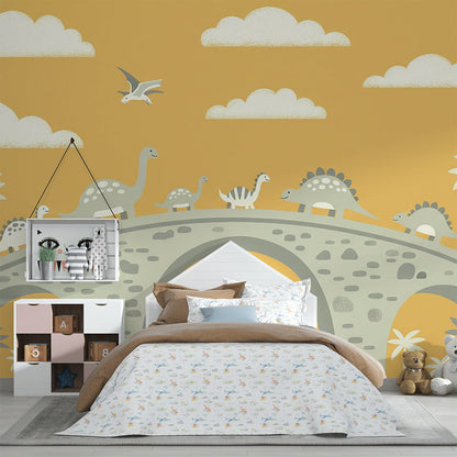 Kids-Mundo dinosaur bridge mural on a kids bedroom wall behind a bed and shelving