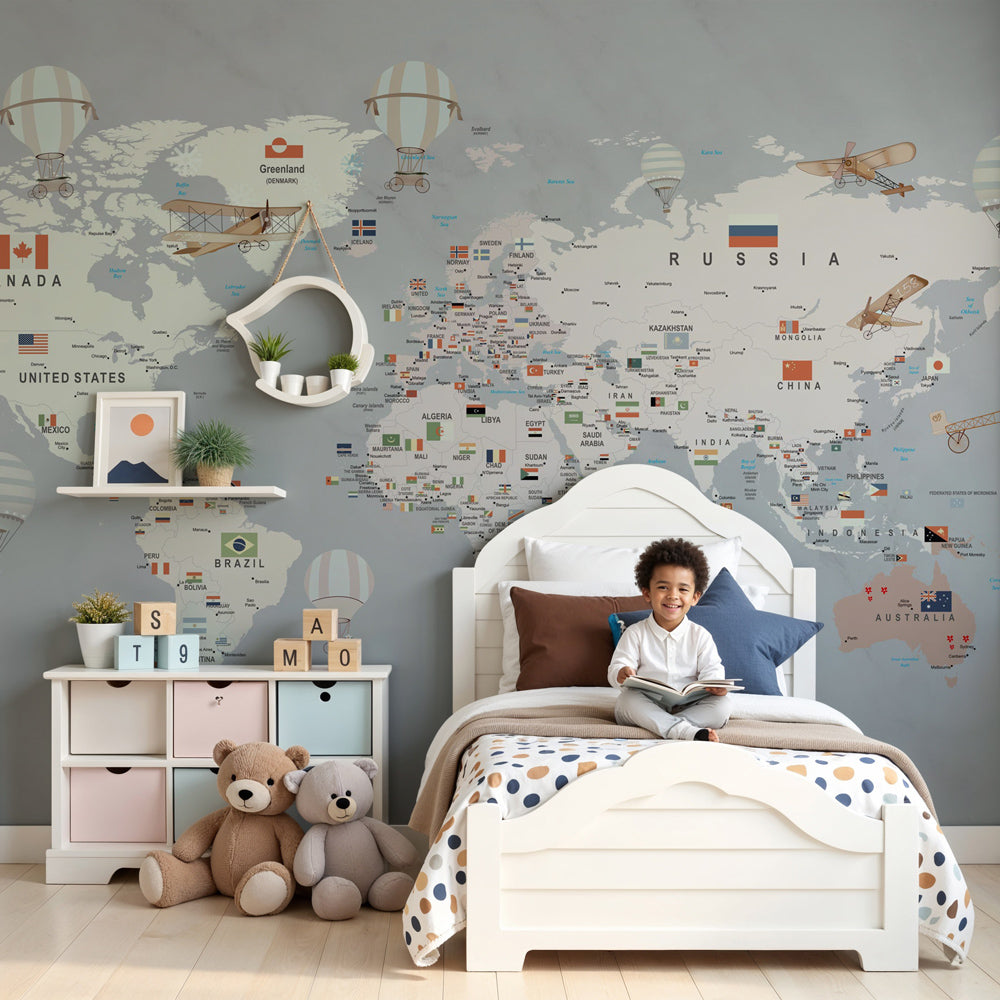 Kids-Mundo grey world map wall mural in a nursery, striped balloons drifting above a soft cream cot.